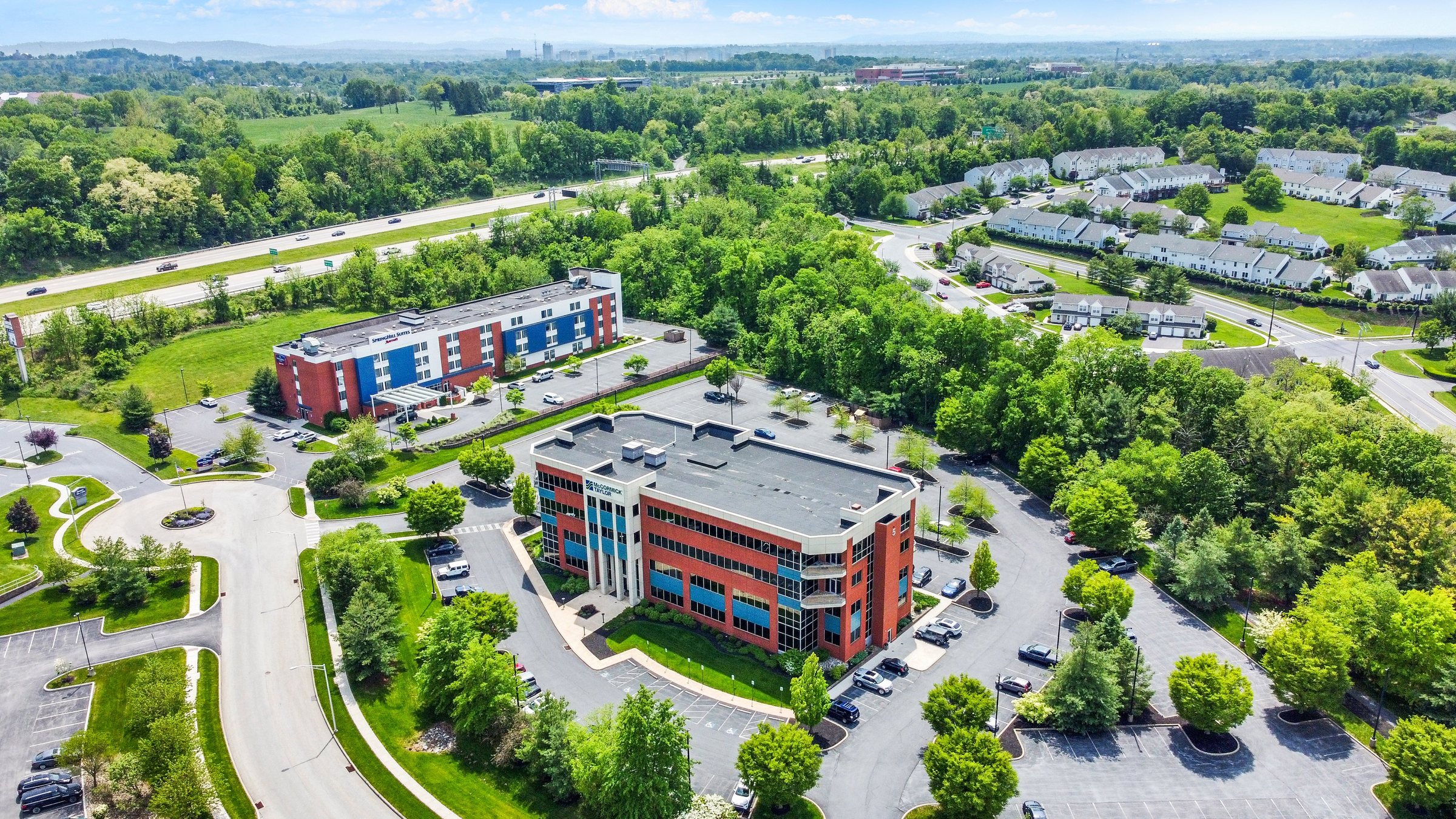 Aerial showing 5 Capital Drive, SpringHill Suites, and I-81 through the trees